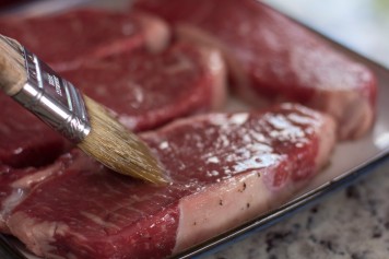 Brushing oil on steak